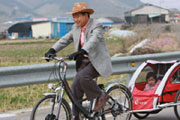 Former South Korean President Roh Moo-hyun cycling with grandchildren